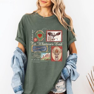 A woman wearing a green t-shirt with a collage of various images, including a bird, a castle, and a deer, along with the text "To What End" and "I will not be satisfied".
