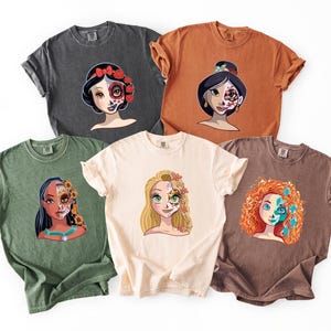 a collection of six t-shirts, each featuring a different cartoon character with unique facial features and hairstyles.