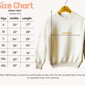 May include: Cream-colored Gildan 1800 unisex tee sweatshirt hanging on a wooden hanger. The size chart shows measurements in inches: S (20" width, 27" length), M (22" x 28"), L (24" x 29"), XL (26" x 30"), 2XL (28" x 31"), 3XL (30" x 32"), and 4XL (32" x 33").