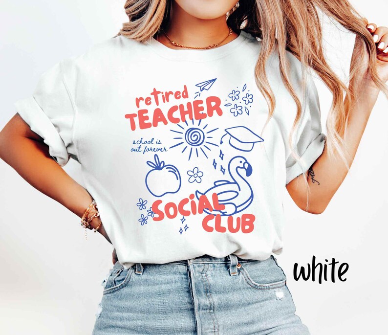 May include: White t-shirt with a graphic design in red and blue. The design includes the words "retired TEACHER SOCIAL CLUB" with illustrations of a sun, apple, graduation cap, and a flamingo floatie. The text "school is out forever" is also included.
