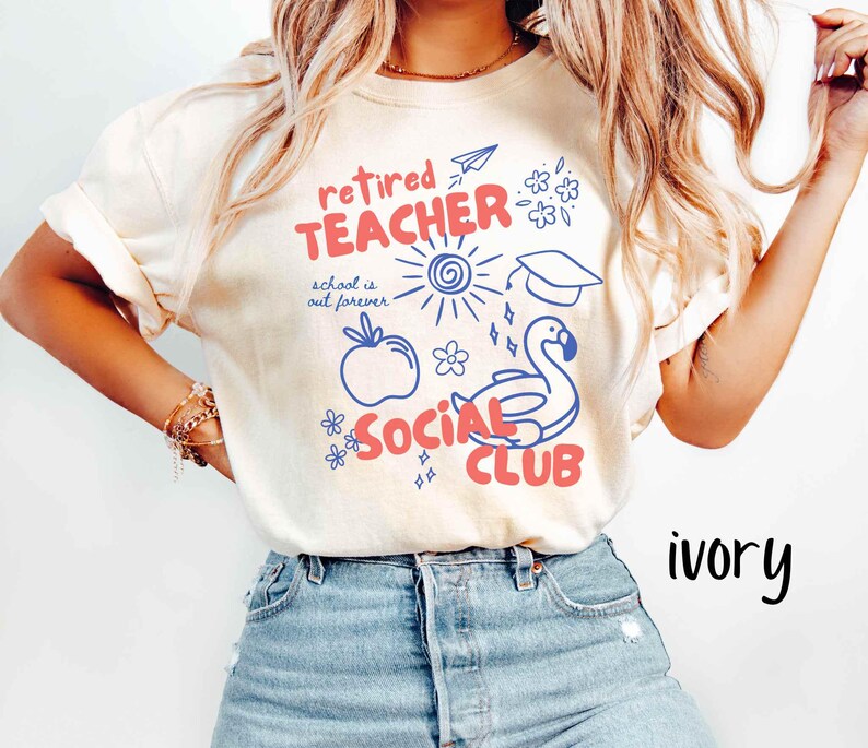 May include: Ivory-colored t-shirt with a graphic design in red and blue. The design includes the words "Retired Teacher Social Club" with illustrations of a sun, apple, graduation cap, and a swan.