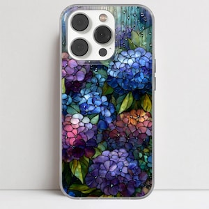 Può includere: Custodia trasparente per telefono con un design a vetrata di fiori di ortensia. I fiori sono in tonalità viola, blu, rosa e arancione, con foglie verdi. La custodia ha una finitura lucida e un ritaglio per la fotocamera.