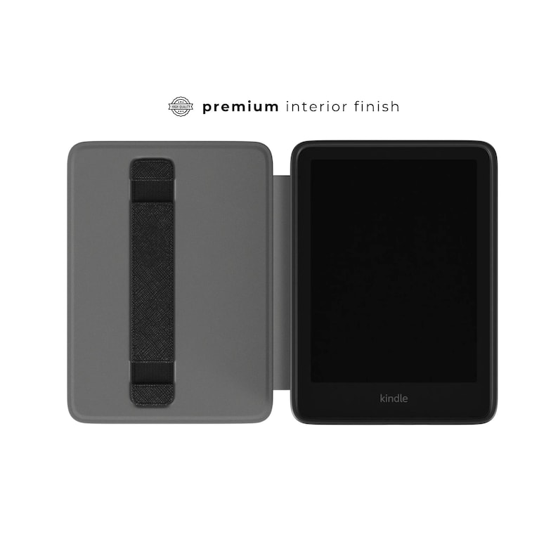 May include: A gray e-reader case with a black hand strap is open, revealing a black e-reader with the brand name "Kindle" at the bottom. The text "premium interior finish" is above the case.
