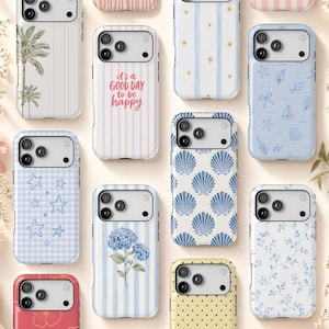 May include: A collection of ten smartphone cases featuring various designs including palm trees, pink stripes with the text it's a GOOD DAY to be happy, blue nautical patterns, stars, blue hydrangea flowers, seashells, and delicate floral vines.
