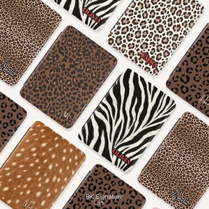 May include: A collection of rectangular cases featuring various animal print patterns including leopard, cheetah, zebra, and deer fur designs. Several cases are personalized with names such as Olivia, Emma, and Amelia, or initials like AR.