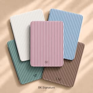 May include: Five rectangular cases with vertical stripes in white, light blue, pink, teal, and brown. The pink, teal, and brown cases feature personalized initials BC, SP, and LM respectively. The text BK Signature is printed at the bottom.