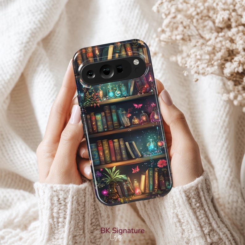May include: A phone case with a detailed illustration of a bookshelf filled with books, plants, and glowing bottles. The design includes butterflies and a magical, whimsical aesthetic. The text "BK Signature" is at the bottom.