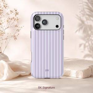 May include: A light purple and white vertically striped phone case featuring a rectangular camera cutout at the top and the letters BW printed in a dark purple font near the bottom center of the back panel.