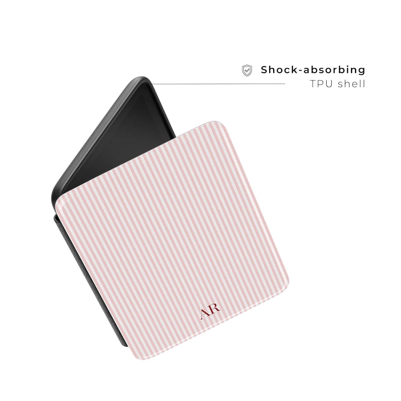 May include: A phone case with a pink and white striped pattern. The case is open, revealing the black phone interior. The text "Shock-absorbing TPU shell" is visible. The initials "AR" are printed on the case.