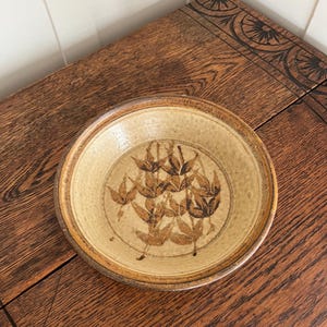 May include: A rustic wooden sign with the text "Welcome to our home" in a handwritten style. The sign features a distressed finish and a simple, inviting design, perfect for a front porch or entryway.