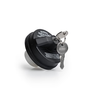 May include: A black locking gas cap with a key. The cap has the text "WARNING REMOVE SLOWLY" printed on it. The key is silver and has the number "GC321" printed on it.