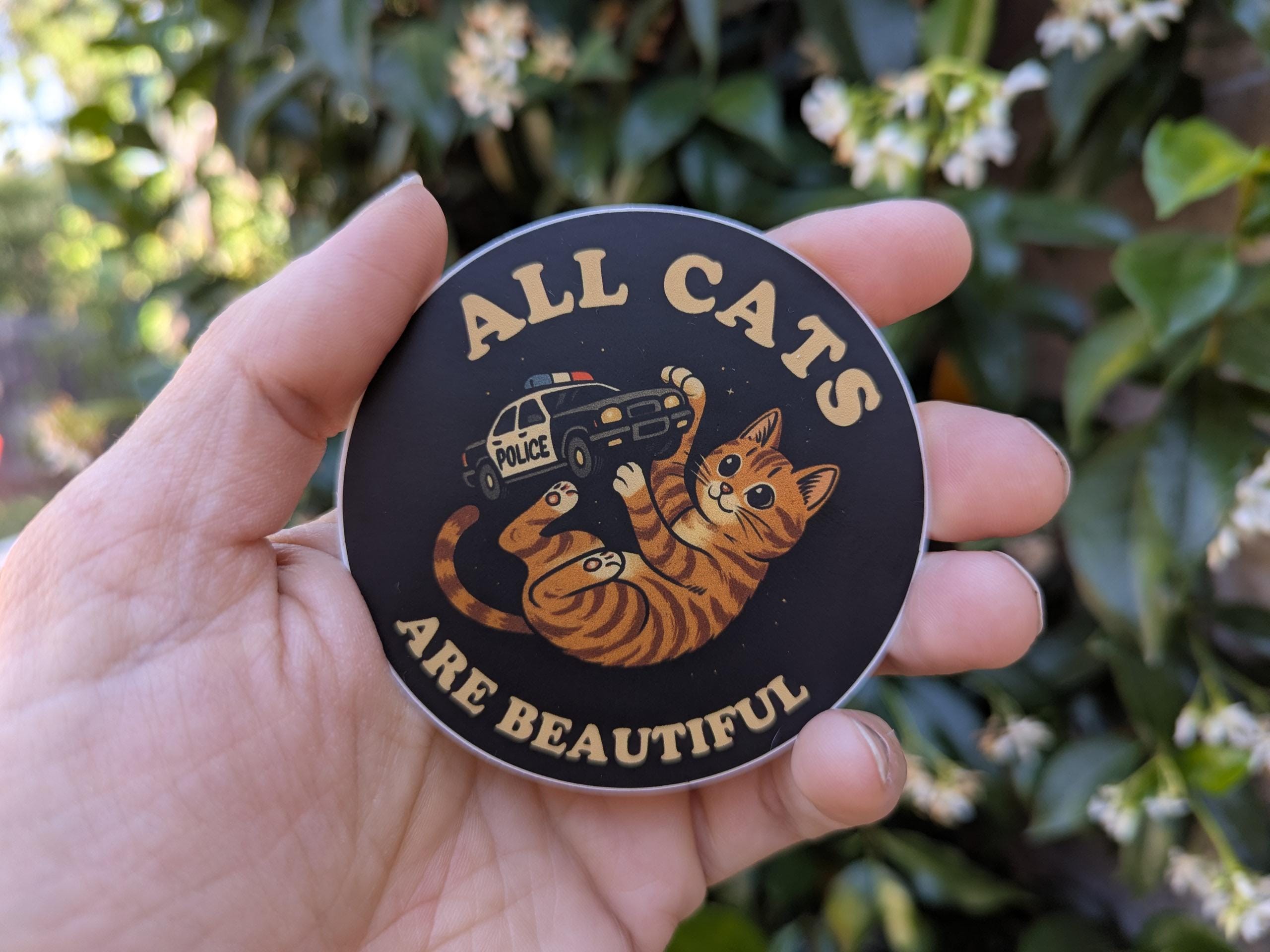 All Cat are Beautiful- kitty playing with cop car sticker 3" - Thumbnail 2