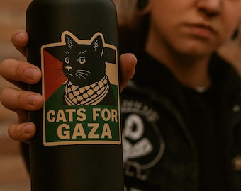 May include: Black water bottle with a black cat graphic wearing a scarf with the colors of the Palestinian flag. The text "CATS FOR GAZA" is printed below the cat illustration. The bottle has a black handle.