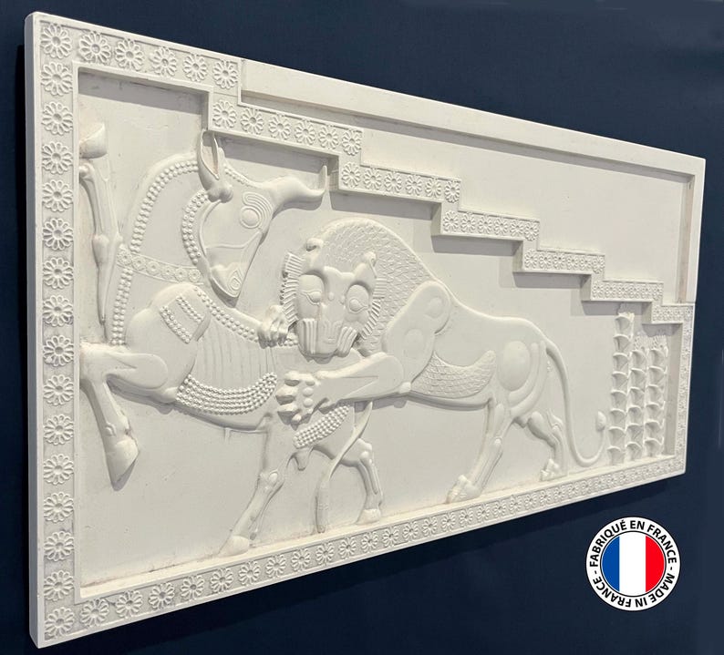 May include: White plaster relief sculpture of a lion attacking a bull. The sculpture is framed by a decorative border of small flowers. The sculpture is made in France.