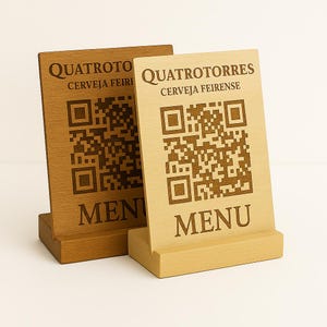 Pode incluir: Dois letreiros de mesa de madeira com um código QR e o texto "MENU" em cada um. O letreiro à esquerda diz "QUATROTOTO CERVEJA FEIRENSE" e o letreiro à direita diz "QUATROTORRES CERVEJA FEIRENSE".