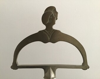 Antique brass Art Deco jewelry stand, faces and arm silhouette