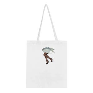 May include: White tote bag with a graphic of a woman's legs with a fish for a skirt. The fish is silver and has fins.