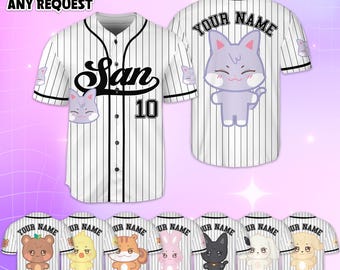 May include: White and black pinstripe baseball jersey with the word "San" and the number "10" on the front. The jersey features a cartoon cat graphic and the text "YOUR NAME" on the back. Additional jerseys with various animal graphics are displayed.