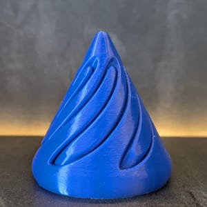 May include: A blue, 3D printed cone with a swirling pattern. The cone is smooth and has a glossy finish.