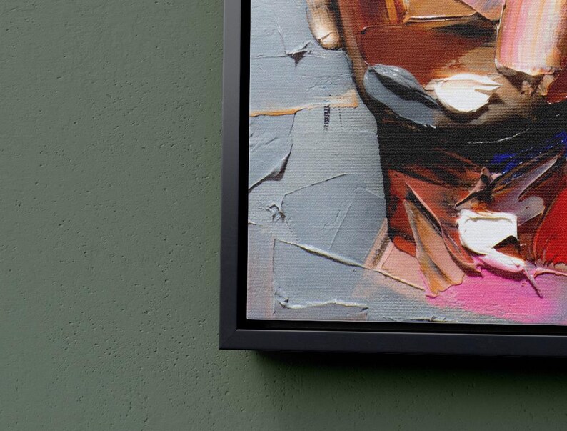 May include: Close-up of a colorful abstract painting with thick brushstrokes. The painting features shades of red, pink, white, and blue. The painting is framed in a black frame.
