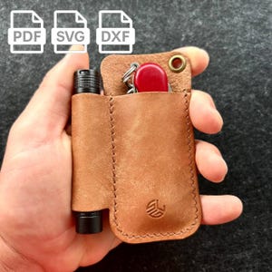May include: A brown leather multi-tool pouch with a flashlight and a red pocket knife. The pouch has a stitched design and a brass grommet. The design includes the PDF, SVG, and DXF file icons.