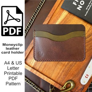 May include: A handcrafted leather card holder in shades of brown and olive green. The wallet features three card slots and a money clip design. The image also includes a PDF icon and text that reads "Moneyclip leather card holder".