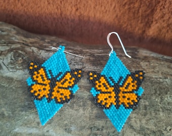 Beaded monarch butterfly on turquoise green