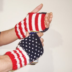 May include: A pair of fingerless gloves with a red, white, and blue striped pattern. One glove has a white background with red stripes, and the other has a navy blue background with white stars.