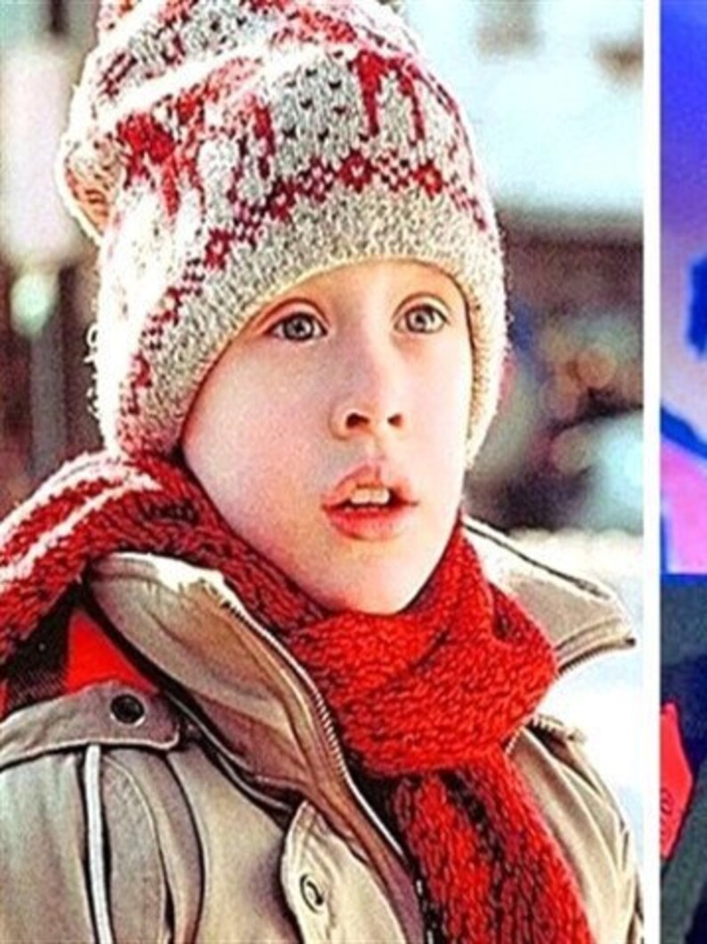 May include: A young person wearing a beige winter coat, a red scarf, and a knit hat with a red and white pattern. The person is looking up with a slightly open mouth. The image is a medium close-up.