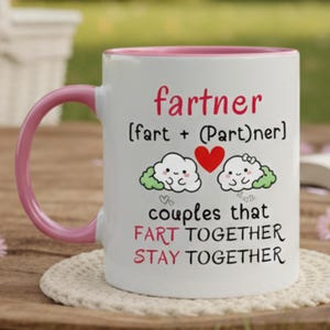 May include: White ceramic mug with a pink handle and rim. The mug features the word "fartner" in red, with the definition "fart + (Part)ner" below. Cute cloud illustrations and the phrase "couples that FART TOGETHER STAY TOGETHER" are also printed on the mug.