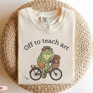 Off to Teach Art Shirt, Funny Frog Art Teacher Tee, Frog on Bicycle Painter Gift, Women Art Educator Shirt, Cute Artist Frog Graphic Top