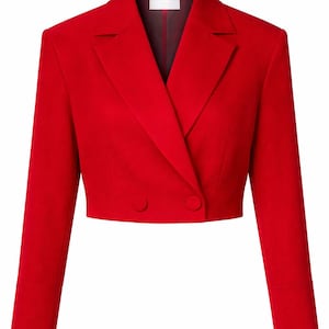 May include: A cropped, double-breasted blazer in a vibrant red hue. The jacket features a notched lapel, two matching buttons, and long sleeves with cuff details. The tailored design suggests a modern, stylish aesthetic.