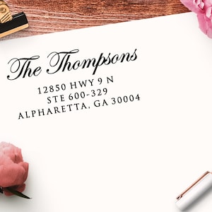 Address stamp impression in black ink on a white envelope. The first line of the return address stamp reads "The Thompsons" in an elegant script font. The address is in a crisp serif font.