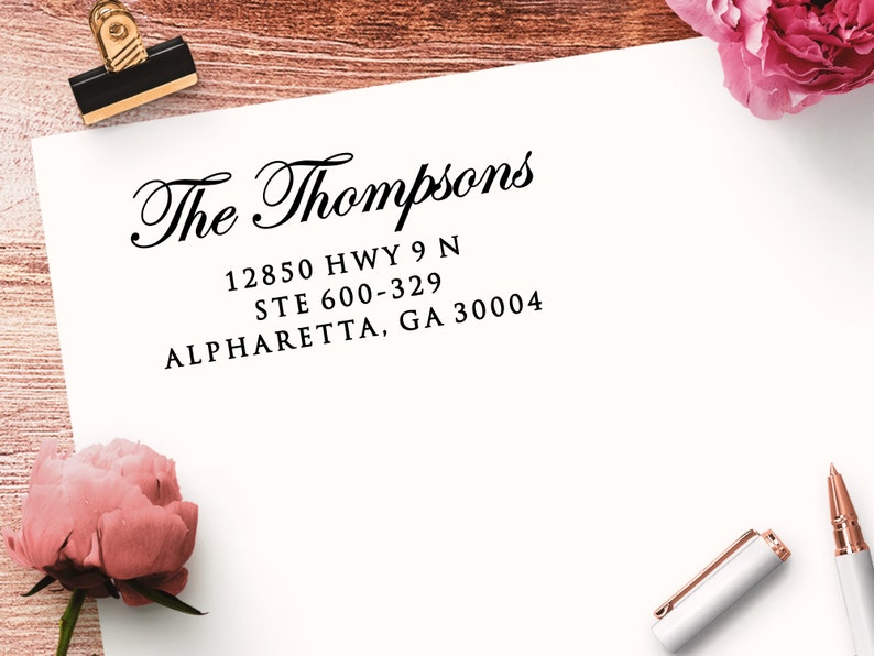 Address stamp impression in black ink on a white envelope. The first line of the return address stamp reads "The Thompsons" in an elegant script font. The address is in a crisp serif font.
