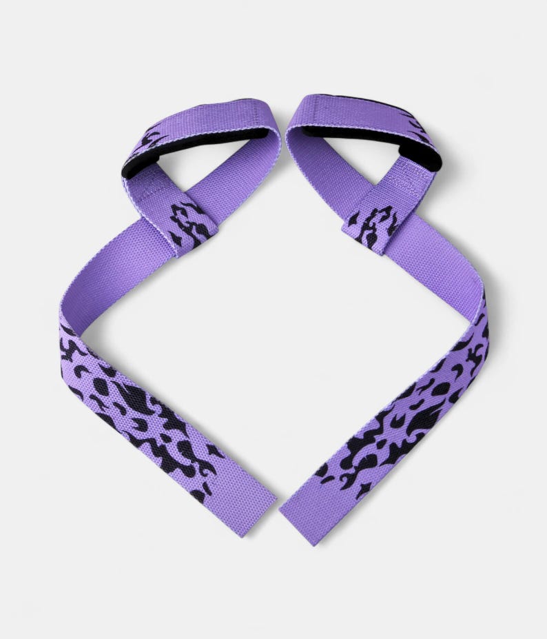 Two purple powerlifting straps with anime flame design and padded loops. Fitness accessory for wrist support during weightlifting and gym workouts.