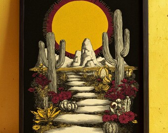 May include: Framed art print featuring a desert landscape with a large yellow sun and cacti. A stone path leads through the scene, surrounded by red and yellow desert plants. The artwork is set against a black background.