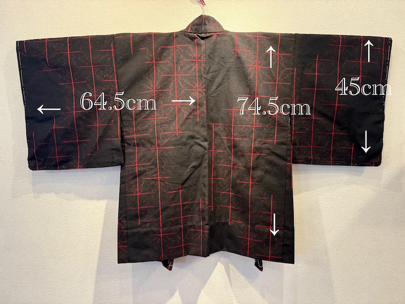 May include: Black kimono with a red grid pattern. The kimono measures 74.5 cm across the back, 64.5 cm for the sleeve length, and 45 cm for the sleeve width. The garment is hanging on a hanger.