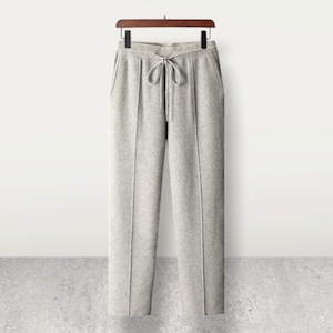 May include: Gray sweatpants with a drawstring waist and side pockets.