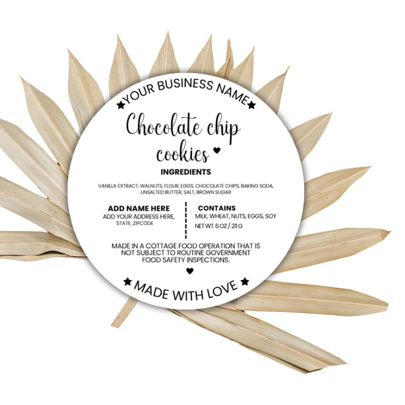 May include: A white circular label with the text "Chocolate chip cookies" and a list of ingredients. The label is surrounded by dried, light brown leaves. The label also includes the text "Made with Love".