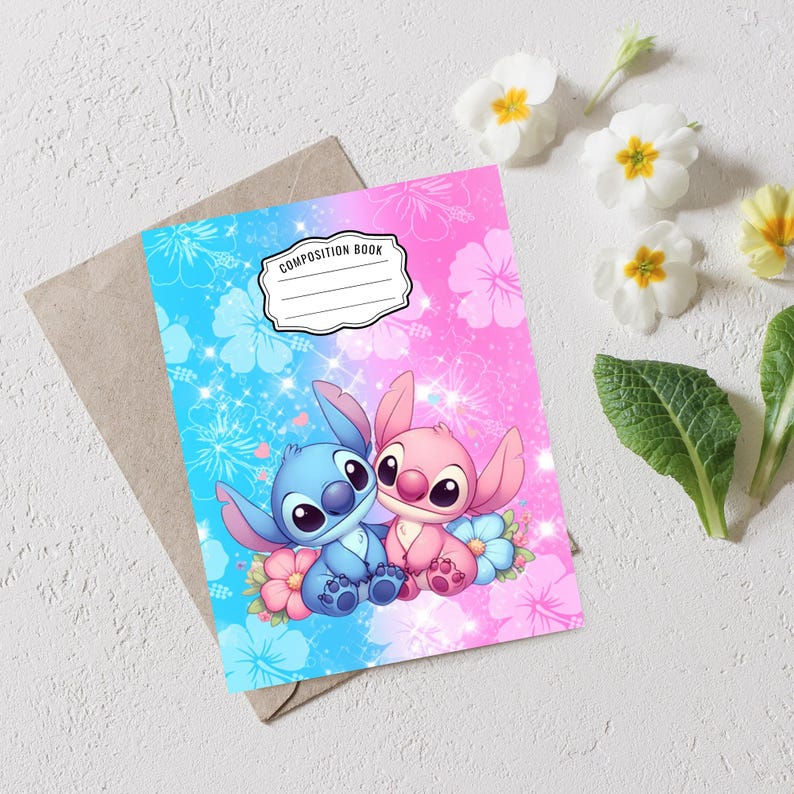 May include: A composition book with a blue and pink floral design featuring cartoon characters. The cover has the words "Composition Book" in a white label. The characters are blue and pink, surrounded by flowers.