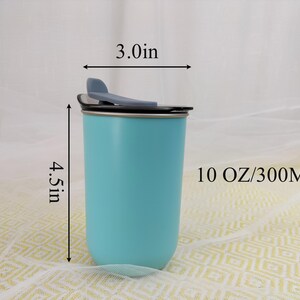 May include: A light blue insulated tumbler with a black lid and a flip-top closure. The tumbler is 4.5 inches tall and 3.0 inches wide, with a capacity of 10 oz. The tumbler is designed to keep beverages hot or cold.
