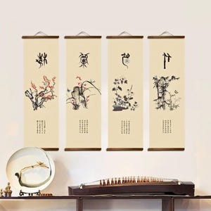 May include: Four vertical wall scrolls with traditional Asian art. Each scroll features a different ink painting of flowers, plants, and bamboo, with calligraphy. The scrolls are cream-coloured with wooden rods at the top and bottom.