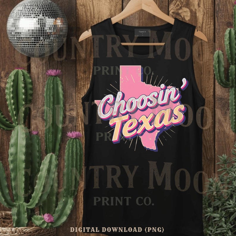 May include: Black vest top with the text "Choosin' Texas" in pink, yellow, and white. The design features a pink outline of the state of Texas. The vest top is hanging on a wooden hanger.