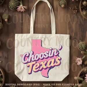 May include: Cream tote bag featuring the phrase "Choosin' Texas" in a retro font, with a pink outline of Texas. The bag has two handles and is made of a sturdy fabric. The design is a digital download mock-up.