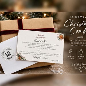 May include: A brown gift box with a dark red velvet ribbon, a white envelope with a number 12 sticker, and a card titled 12 Days of Christmas Comfort. The card features text about simmer pots and intention cards, with orange and pine illustrations.