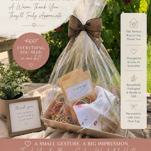 May include: A hostess gift basket kit wrapped in clear cellophane with a brown ribbon bow. The kit includes a glass simmer pot, three simmer kits, a tea towel, crinkle paper, and a gift tag. A small framed sign reads, thank you for opening your home & your heart.