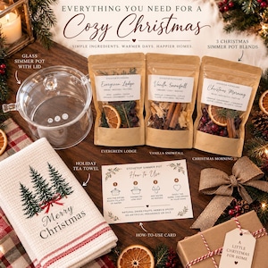May include: A stovetop simmer pot kit including a clear glass pot with lid, three kraft paper pouches labeled Evergreen Lodge, Vanilla Snowfall, and Christmas Morning, a white tea towel with pine trees, and a how-to-use instruction card.