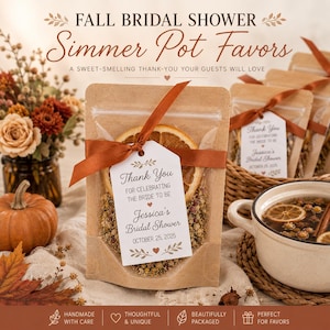 May include: A kraft paper pouch containing dried orange slices and botanicals for a simmer pot, tied with a rust-colored ribbon and a white tag reading Thank You FOR CELEBRATING THE BRIDE TO BE Jessica's Bridal Shower OCTOBER 25, 2025.