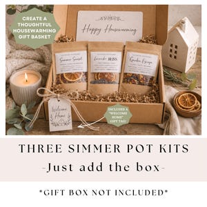 May include: A housewarming gift set featuring three simmer pot kits in a cardboard box. The kits are labeled "Summer Sweet", "Lavender Bliss", and "Garden Escape". A lit candle, a decorative house, and a "Welcome Home" gift tag are also included.