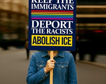 May include: A sign with the text "KEEP THE IMMIGRANTS, DEPORT THE RACISTS, ABOLISH ICE" held by a person. The sign has a navy blue background, white text, and a rainbow stripe. The person is wearing a denim jacket.